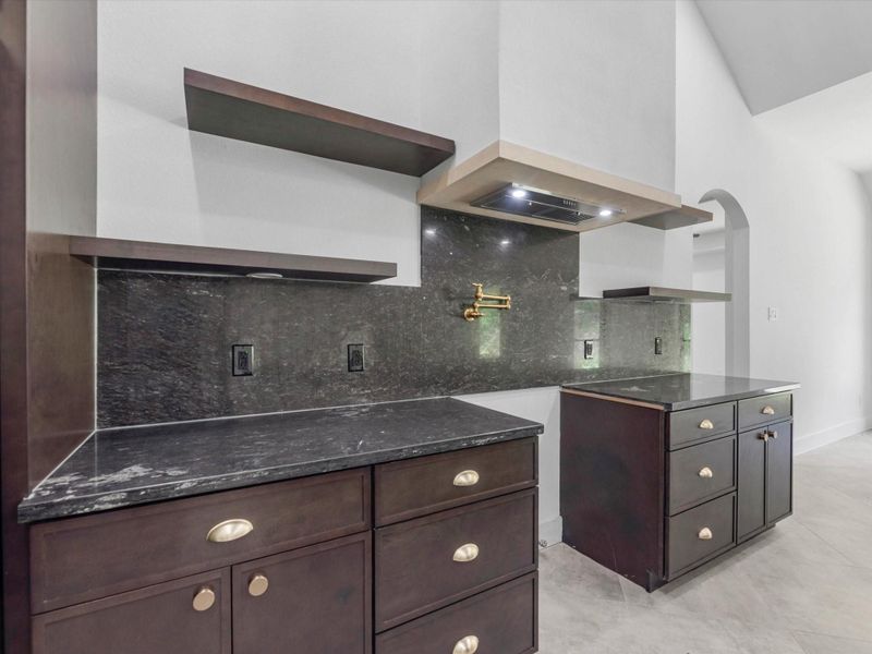 Enjoy this moody kitchen with two tone countertops that complement each other so well!