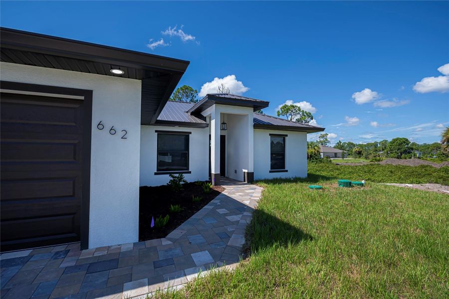 Front exterior of a new home in , Lehigh Acres, FL, highlighting curb appeal (Image 2).