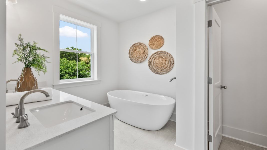 The Sullivan primary bathroom features a soaking tub, modern finishes, and a relaxing design.