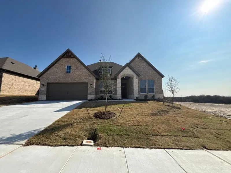 Front exterior of a new home in Waterford Park, Weatherford, TX, highlighting curb appeal (Image 2). Front exterior of a new home in Waterford Park, Weatherford, TX, highlighting curb appeal (Image 2).