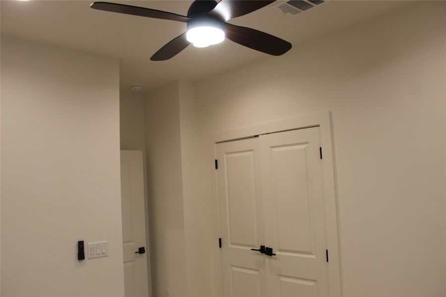 Overhead, a sleek ceiling fan provides comfort and illumination to this inviting space.