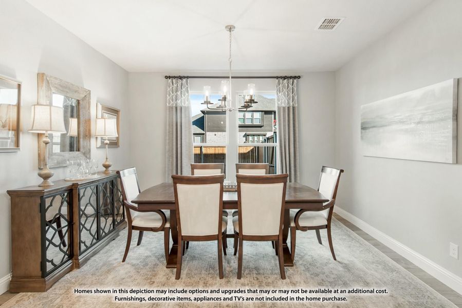 Formal dining room with wood table, six upholstered chairs, chandelier, and buffet sideboard against gray walls.