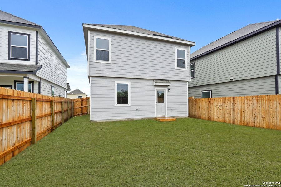 Front exterior of a new home in Melissa Ranch, San Antonio, TX, highlighting curb appeal (Image 1).