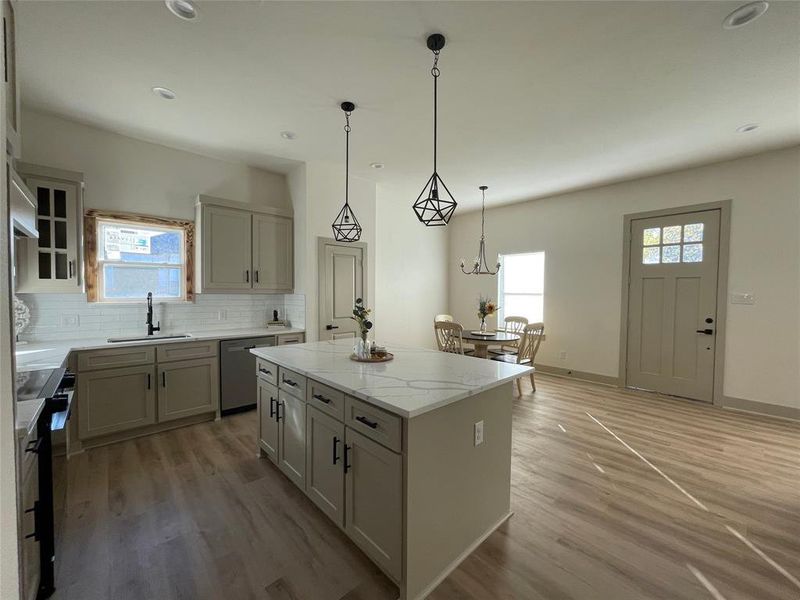 Kitchen featuring kitchen island and dinning room