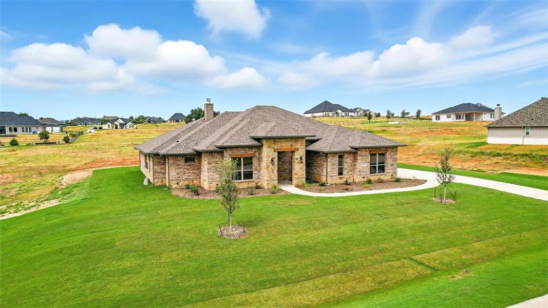 Front exterior of a new home in Rocky Top Ranch, Reno, TX, highlighting curb appeal (Image 20). Front exterior of a new home in Rocky Top Ranch, Reno, TX, highlighting curb appeal (Image 20).