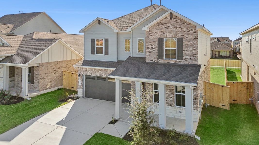 Front exterior of a new home in University Heights, Round Rock, TX, highlighting curb appeal (Image 21).