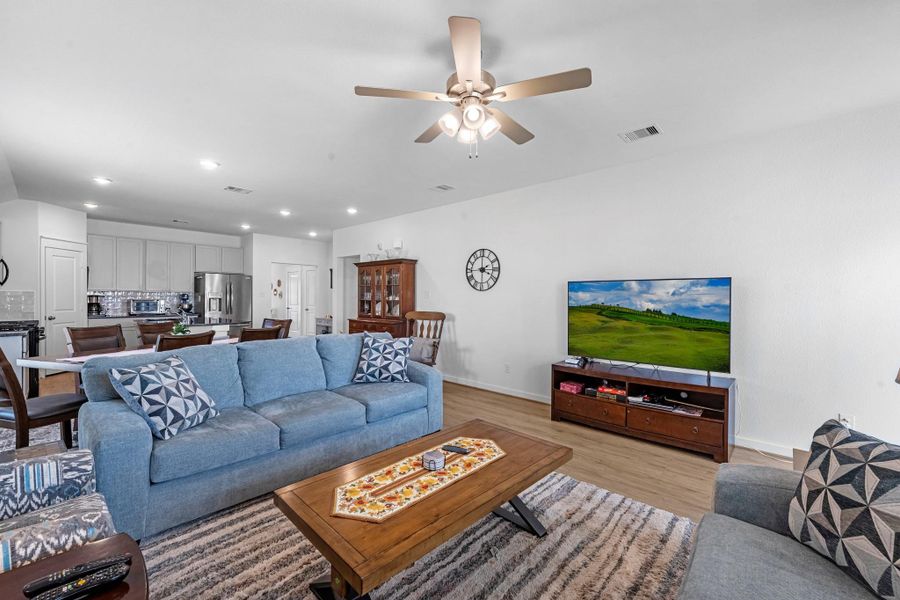 Your family room has ample space to entertain family and friends. This space features beautiful floors, fresh paint, ceiling fan with lighting, and high ceilings.