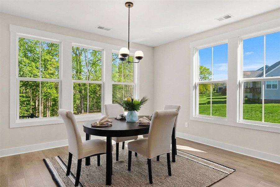 This bright dining area offers abundant natural li