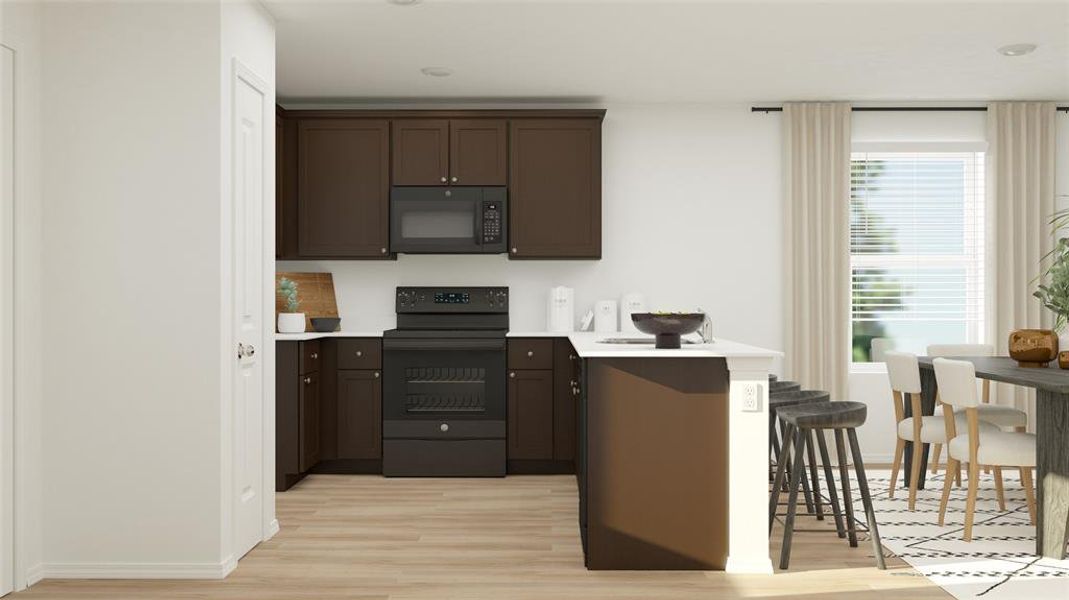 Kitchen with black appliances, light wood-type flooring, a kitchen breakfast bar, and dark brown cabinets Kitchen with black appliances, light wood-type flooring, a kitchen breakfast bar, and dark brown cabinets