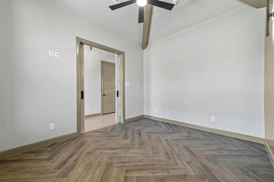 featuring dark wood looking tile floors and ceiling fan