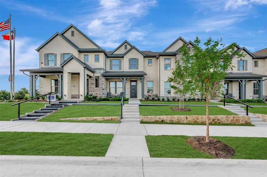 Multi-story townhome featuring light-colored brick and stone veneer Multi-story townhome featuring light-colored brick and stone veneer
