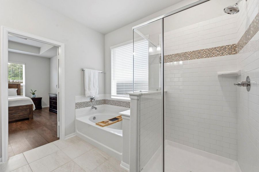 A sleek glass shower and relaxing soaking tub create the perfect luxury bath experience at home. A sleek glass shower and relaxing soaking tub create the perfect luxury bath experience at home.