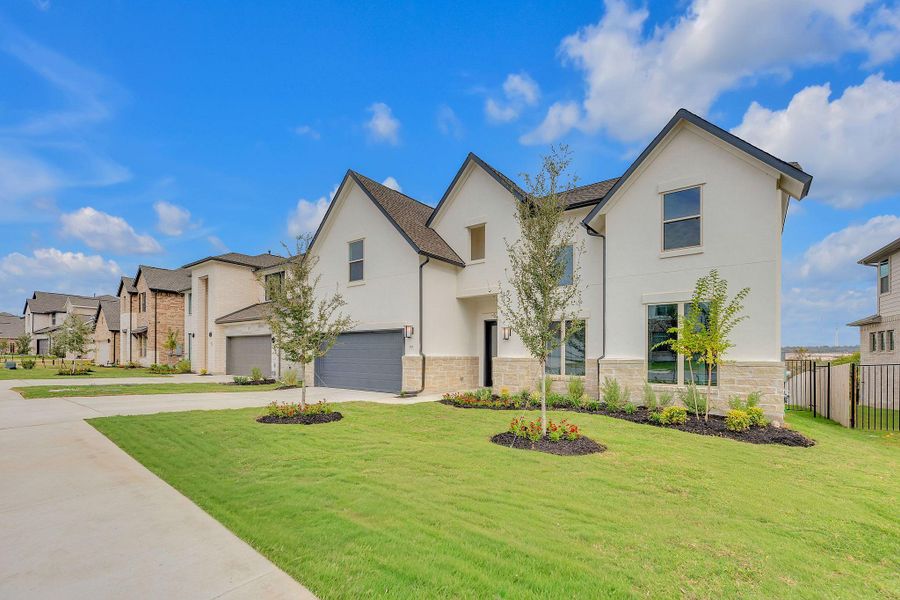 Front exterior of a new home in Santa Rita Ranch, Liberty Hill, TX, highlighting curb appeal (Image 27). Front exterior of a new home in Santa Rita Ranch, Liberty Hill, TX, highlighting curb appeal (Image 27).