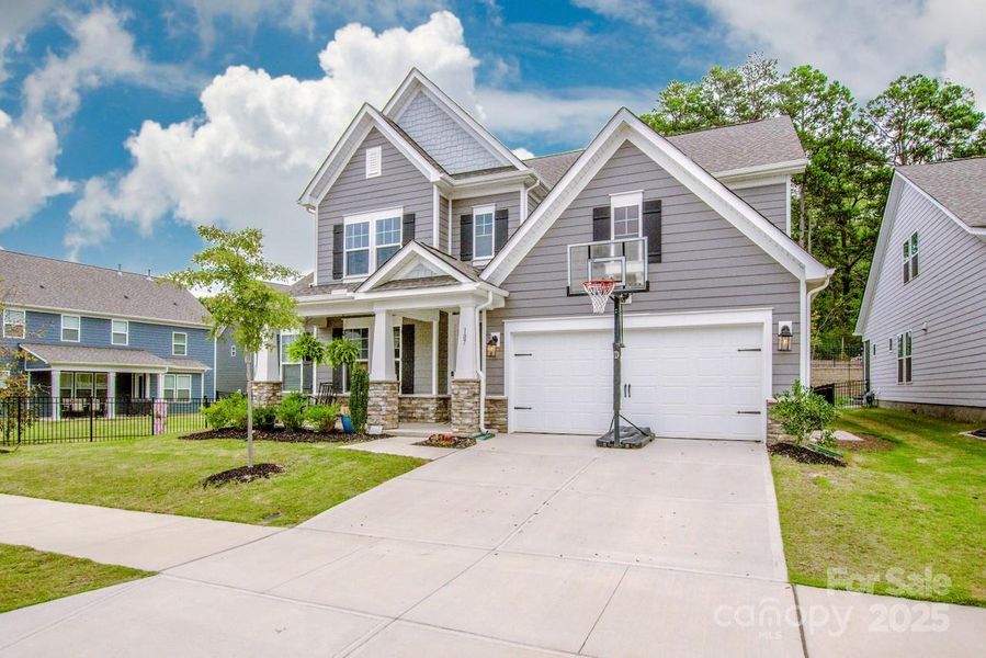 Front exterior of a new home in Signature at Reid's Cove, Mooresville, NC, highlighting curb appeal (Image 1).