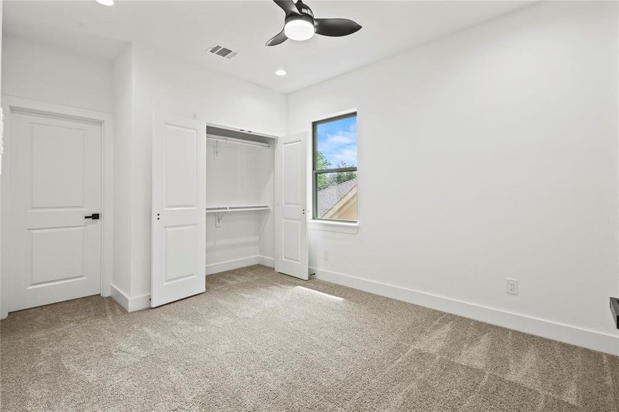 Unfurnished bedroom with a closet, carpet floors, and ceiling fan