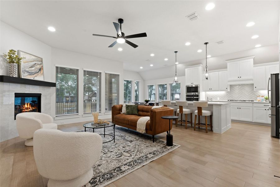 Open-concept living space featuring wood-finish flooring throughout