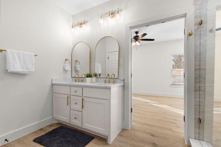 Bathroom featuring vanity, wood-type flooring, and ceiling fan