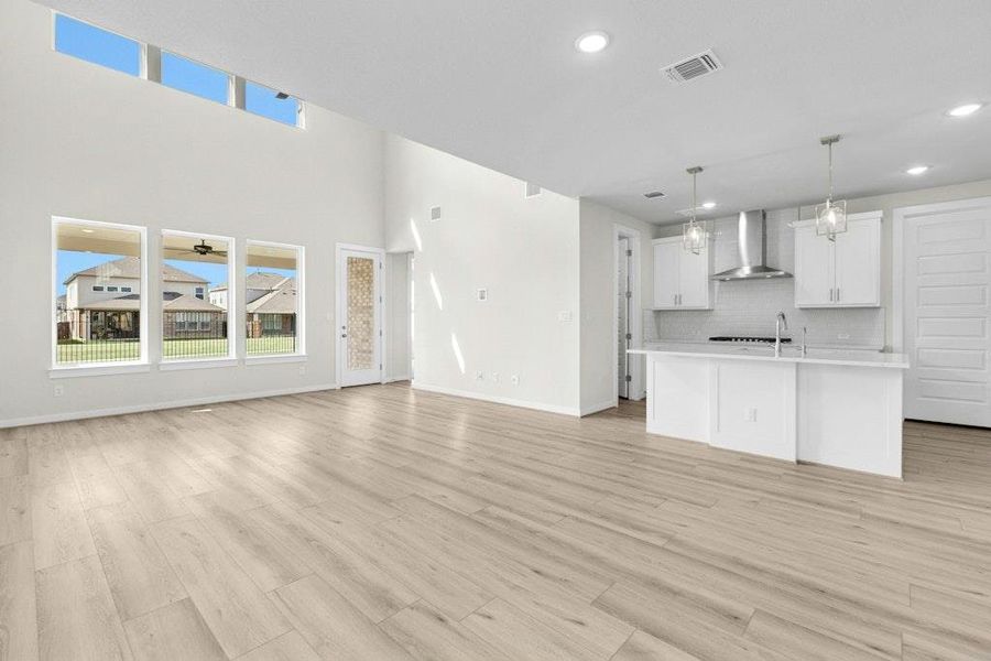 Unfurnished living room featuring light wood-style flooring and recessed lighting