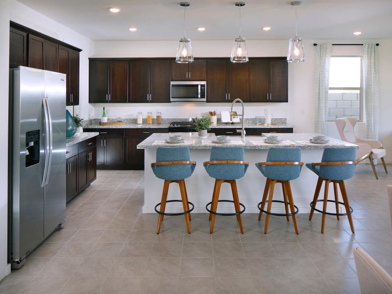 Free flowing kitchen featuring brown cabinets and white granite counter tops