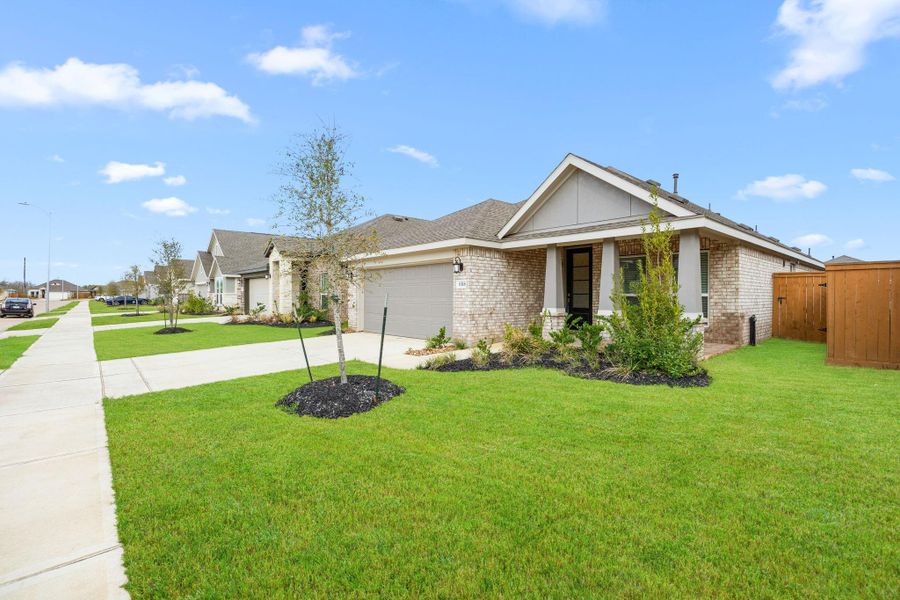 Front exterior of a new home in Sunterra, Katy, TX, highlighting curb appeal (Image 2). Front exterior of a new home in Sunterra, Katy, TX, highlighting curb appeal (Image 2).
