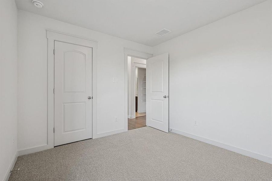 Unfurnished bedroom featuring carpet and baseboards Unfurnished bedroom featuring carpet and baseboards