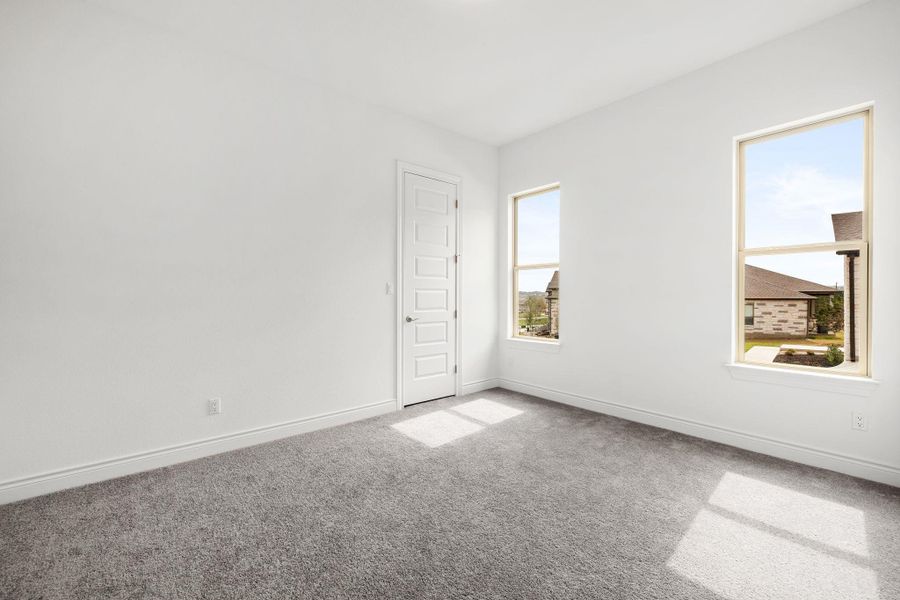 Empty room with carpet and baseboards