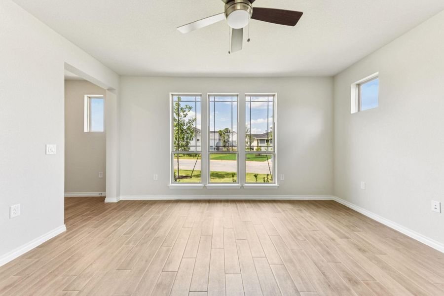 Spare room with light wood-style flooring and a ceiling fan