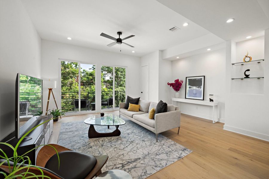 This inviting modern living room is designed with comfort and style in mind. Expansive windows flood the space with natural light, highlighting the clean lines and neutral tones throughout. This inviting modern living room is designed with comfort and style in mind. Expansive windows flood the space with natural light, highlighting the clean lines and neutral tones throughout.