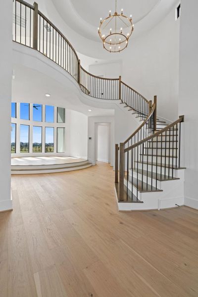 Grand Foyer view entering through the gorgeous double iron front doors with sites into the elegant Formal Dining Room, elevated two-story Living area, winding staircase and curved catwalk with lots of design appeal is coming along beautifully. Gorgeous hardwood flooring is soon to come that will run throughout. Grand Foyer view entering through the gorgeous double iron front doors with sites into the elegant Formal Dining Room, elevated two-story Living area, winding staircase and curved catwalk with lots of design appeal is coming along beautifully. Gorgeous hardwood flooring is soon to come that will run throughout.