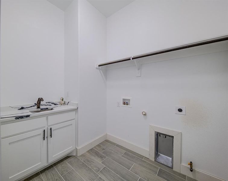 Laundry area with hookup for a washing machine, hookup for a gas dryer, cabinets, and hookup for an electric dryer