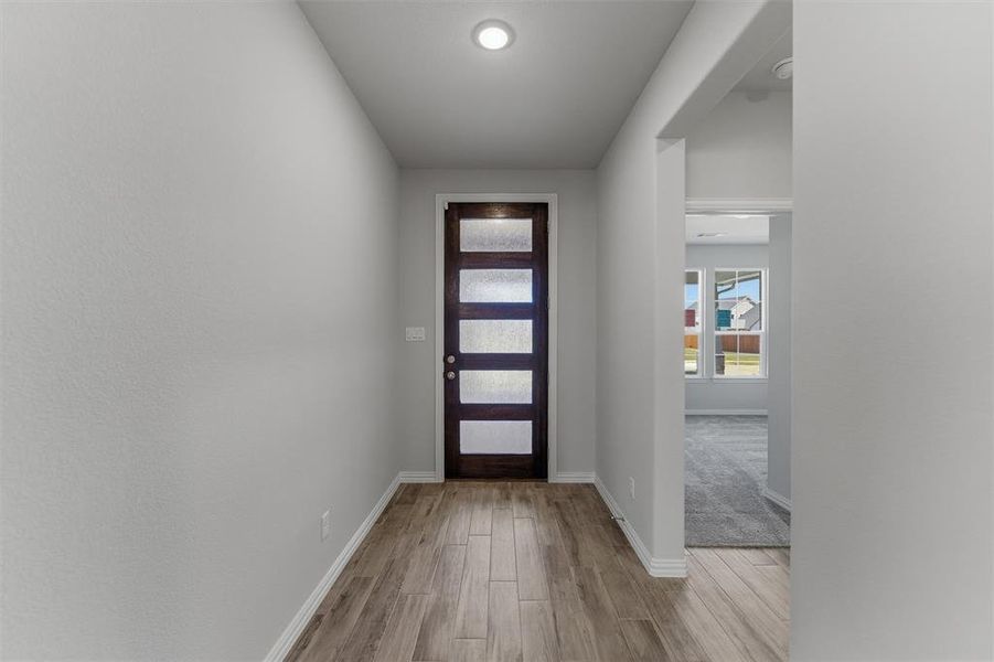 Foyer featuring wood finished floors and baseboards