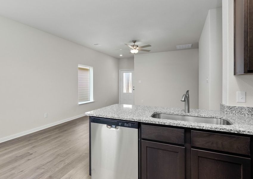 The kitchen looks over into the family room.