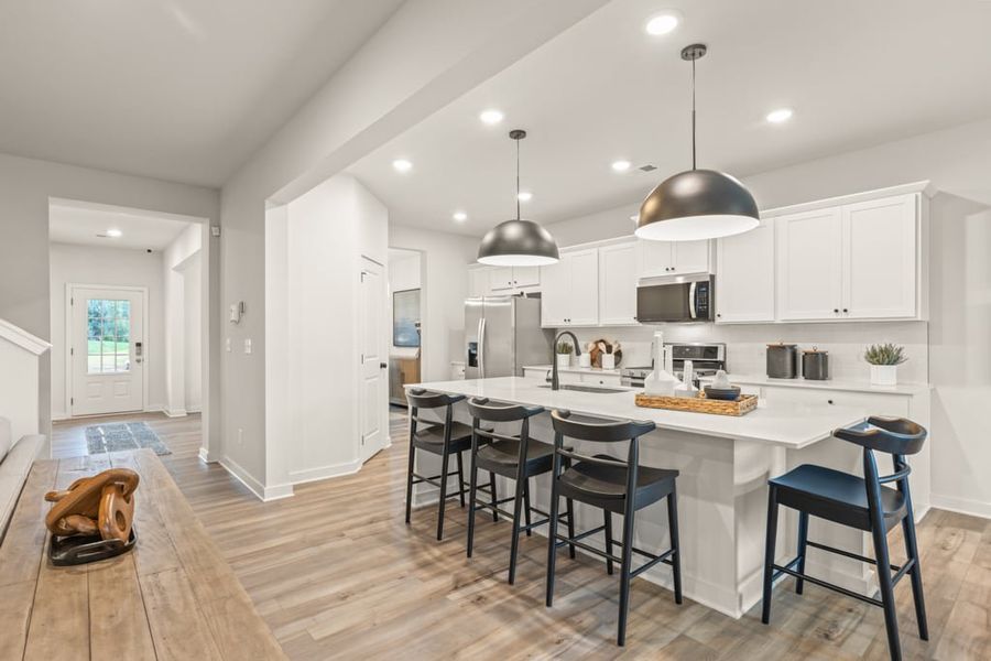 A kitchen with white cabinets.