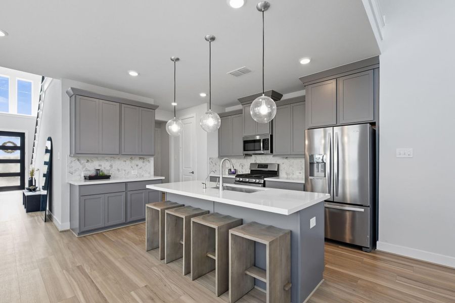 Another view of the kitchen back toward the entry with the open stair in view.