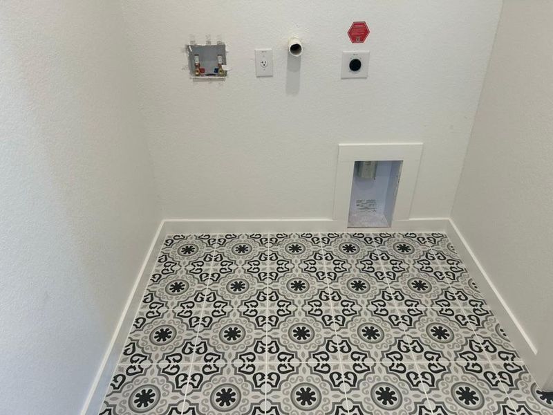 Laundry room featuring tile patterned flooring and hookup for a washing machine