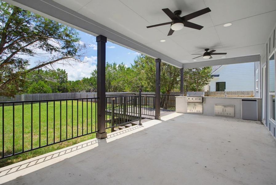 An inviting covered patio features a built-in outdoor kitchen, ideal for al fresco dining and entertaining. An inviting covered patio features a built-in outdoor kitchen, ideal for al fresco dining and entertaining.
