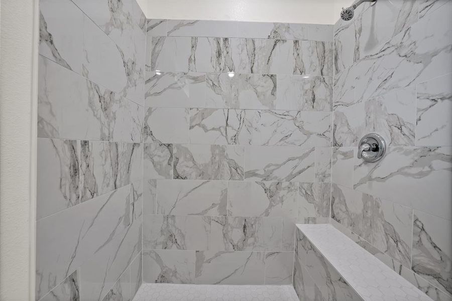 Full bath featuring a tile shower