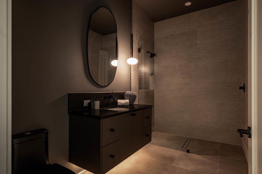Bathroom featuring vanity, light tile patterned flooring, and a walk in shower