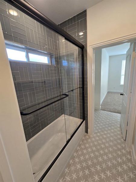 Bathroom with tile patterned floors and a wealth of natural light