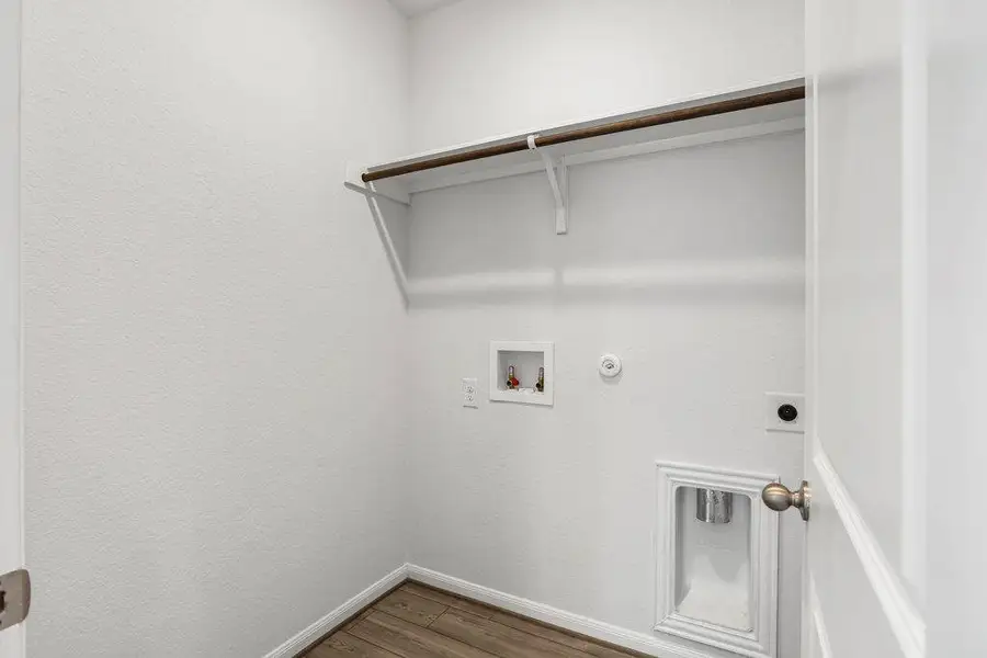 Laundry room with gas dryer hookup, dark wood-type flooring, hookup for a washing machine, and hookup for an electric dryer