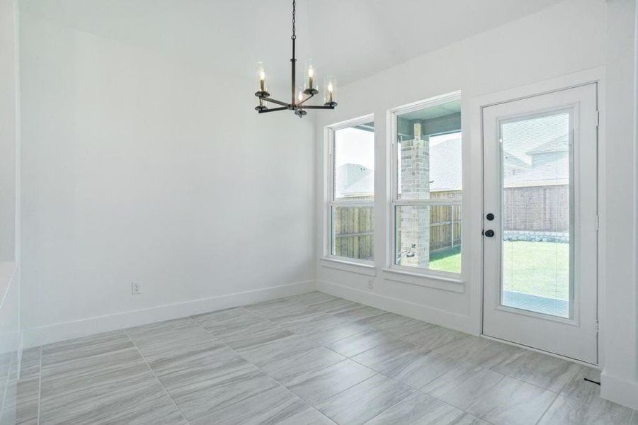 Unfurnished dining area featuring a notable chandelier