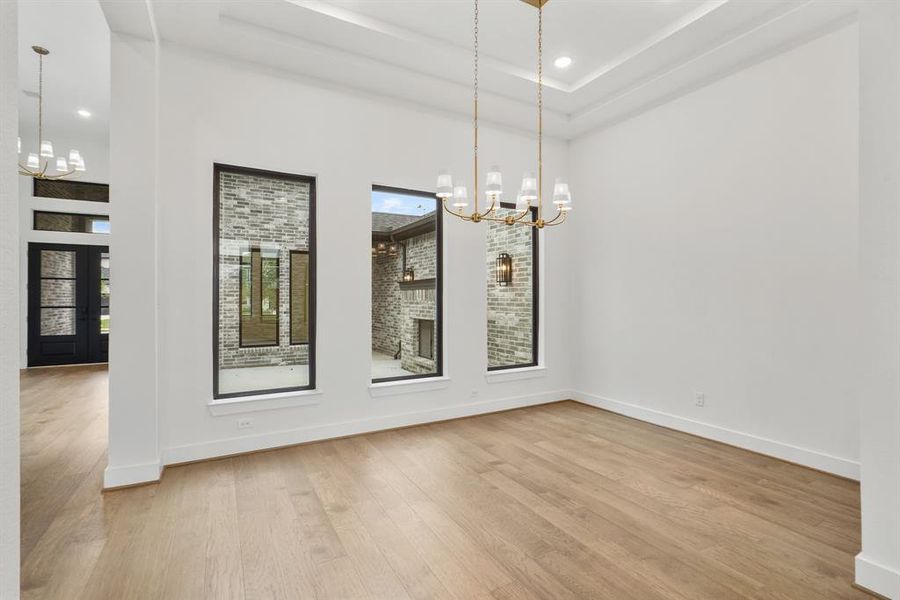 SAMPLE Formal Dining room looking out to the family room and view of the private courtyard.