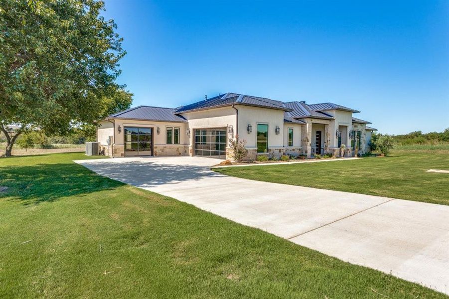 Three-car garage with unique garage doors.