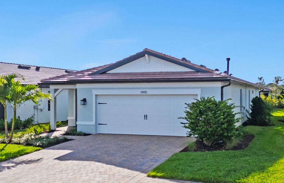 Front exterior of a new home in Terreno, Naples, FL, highlighting curb appeal (Image 2).
