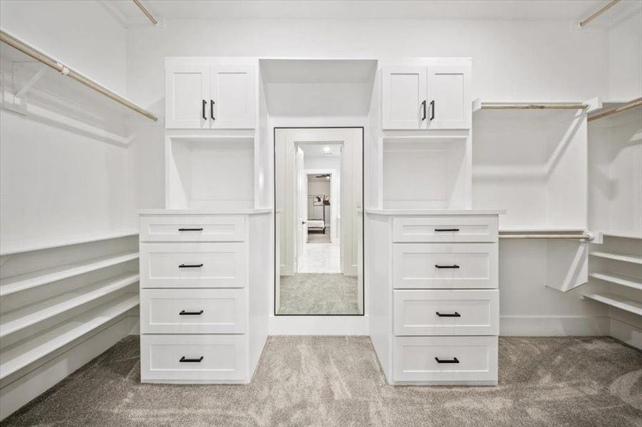 Walk in closet with light carpet