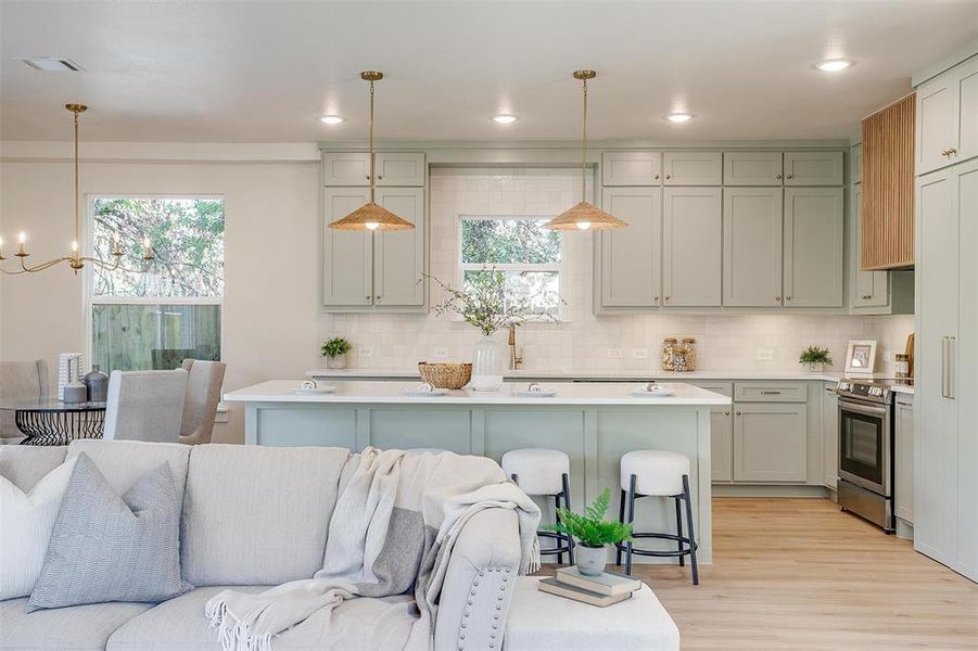 The living room ties in seamlessly with the statement kitchen.