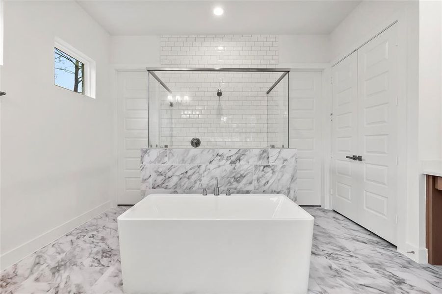 Primary Bathroom with Freestanding Tub, Separate Shower, Linen Closet, and 2 Closets.