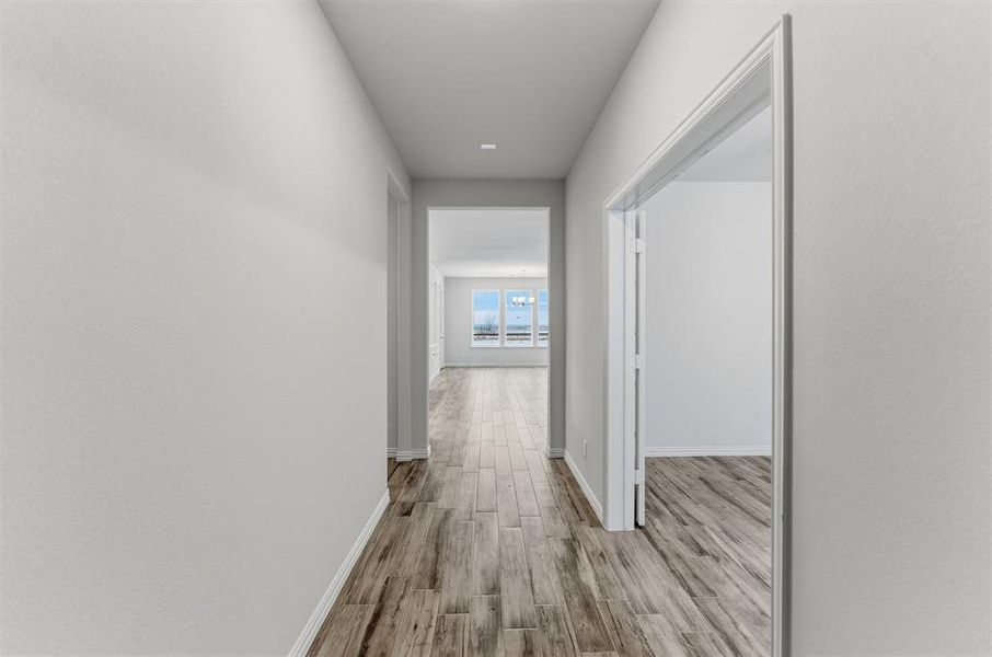 Hall with light wood finished floors and baseboards Hall with light wood finished floors and baseboards