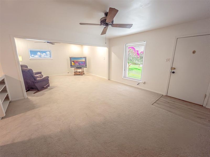 Living room with carpet and ceiling fan Living room with carpet and ceiling fan