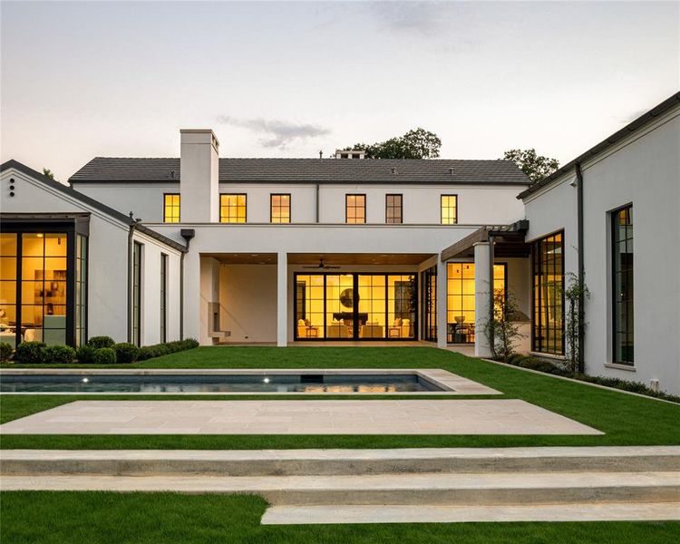 Rear view of house featuring a patio, stucco siding, a ceiling fan, a lawn, and a chimney Rear view of house featuring a patio, stucco siding, a ceiling fan, a lawn, and a chimney